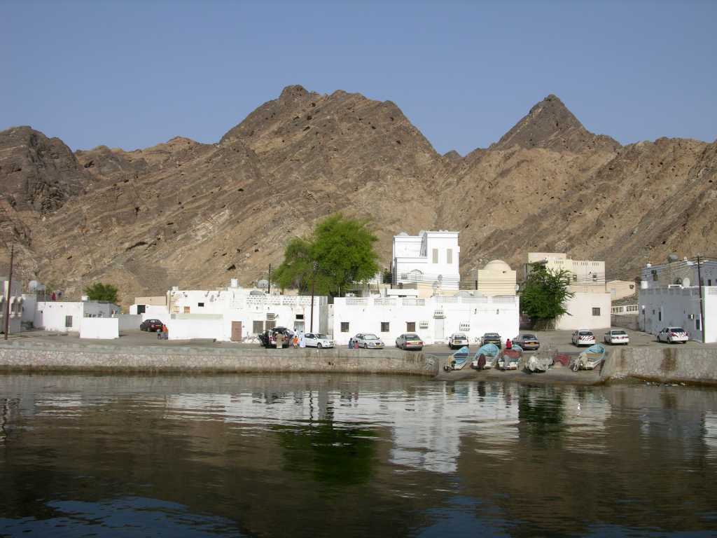 Muscat 03 Mutrah 06 Inlet With Small Village Water creeps under the eastern end of the corniche the entrance to Mutrah to what looks like a small village with fishing boats.